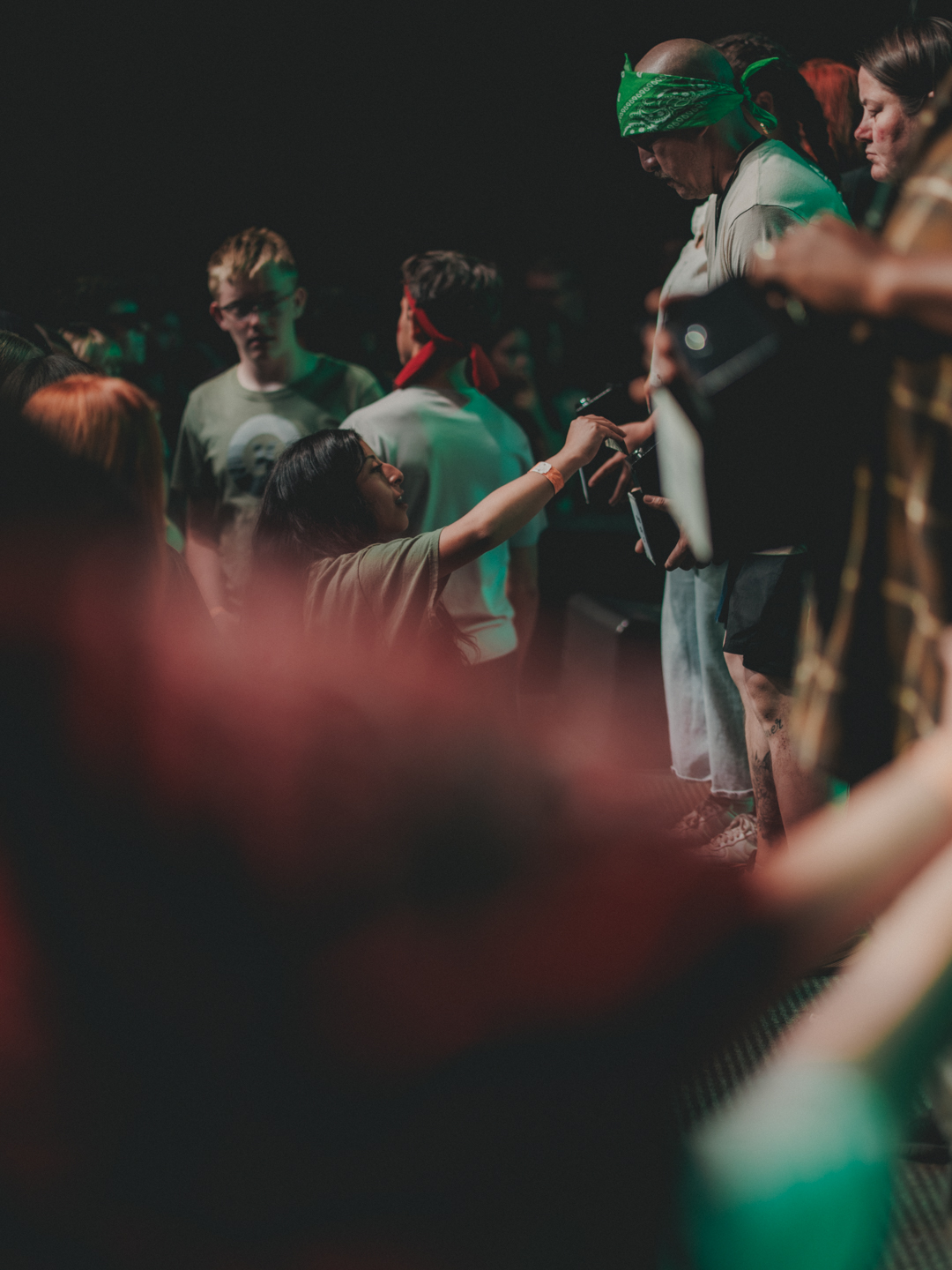 A student reaching out to give during a camp night service