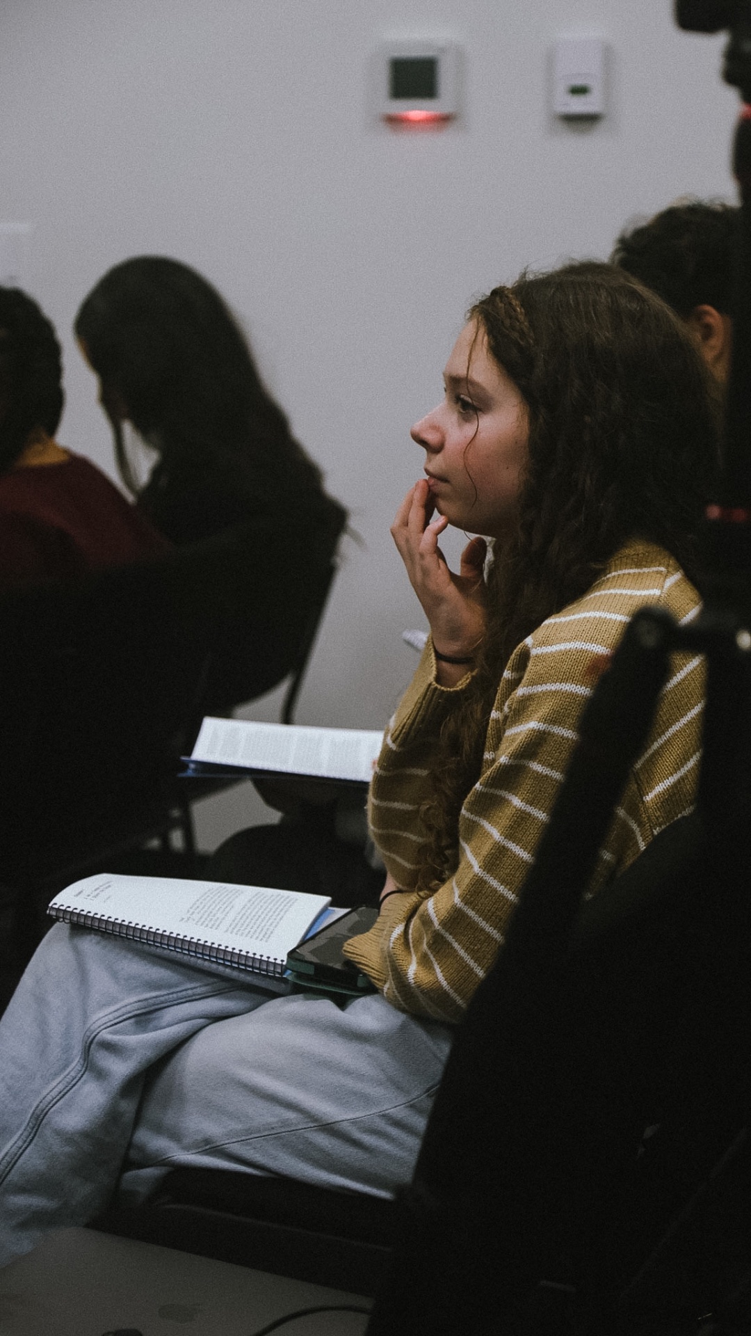 Student listening at a gathering