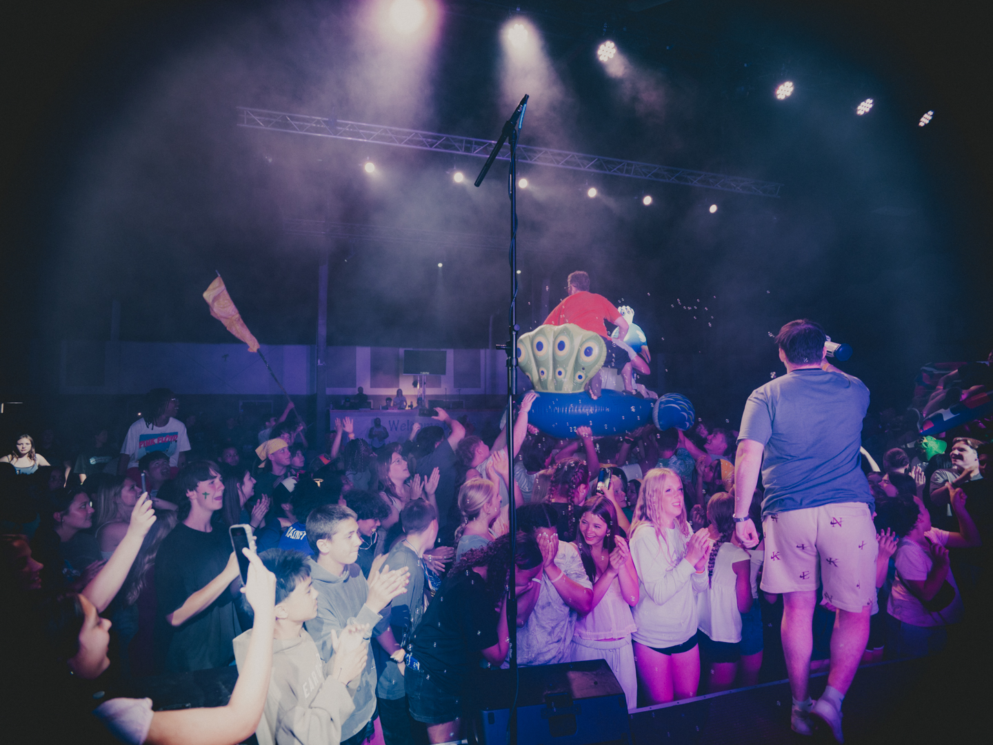Crowd surfing and celebration during a camp night service