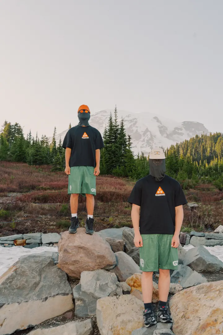 Two campers wearing Cougar Running Shorts in forest green