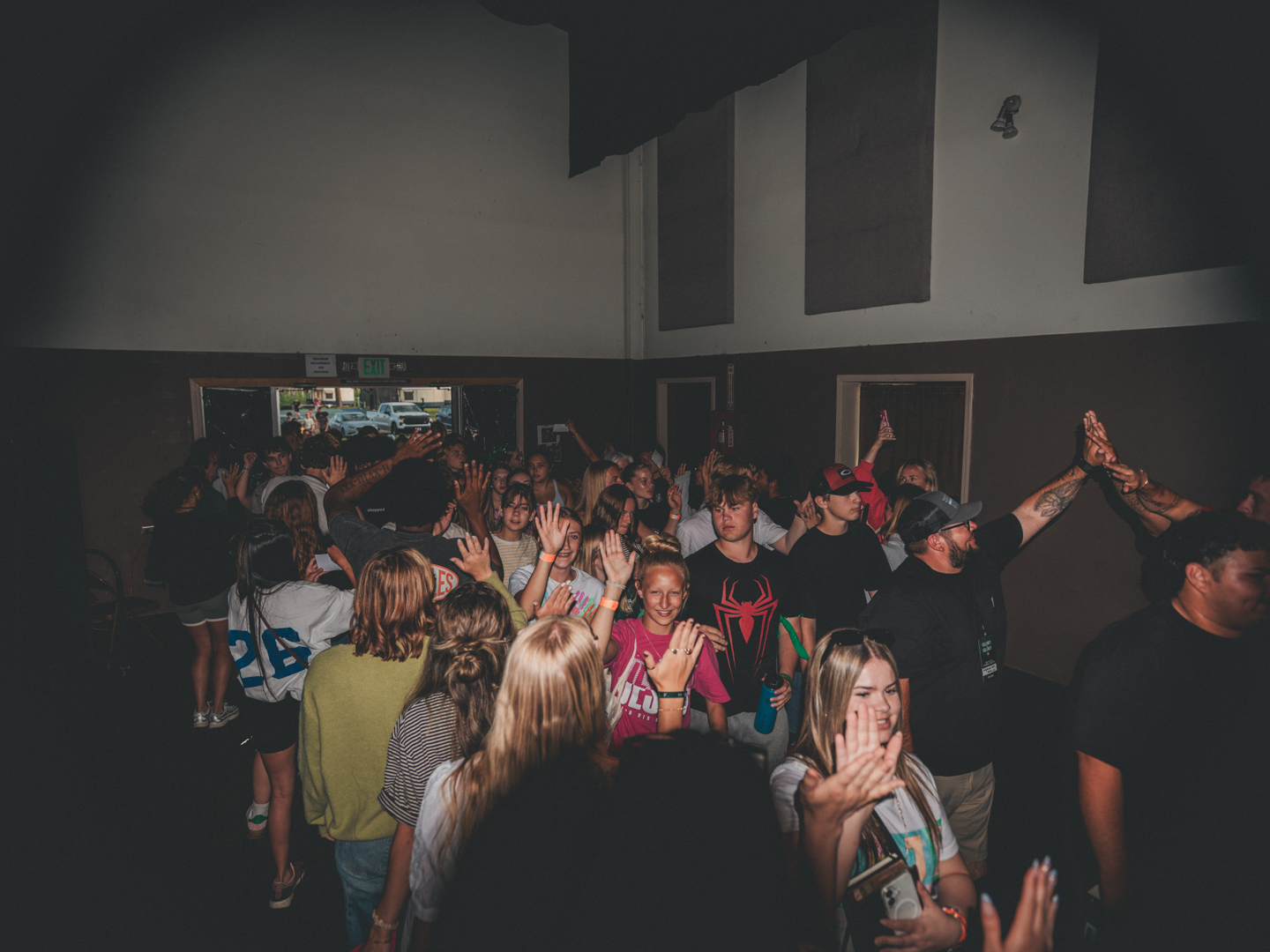 Students worshiping with hands lifted high at camp